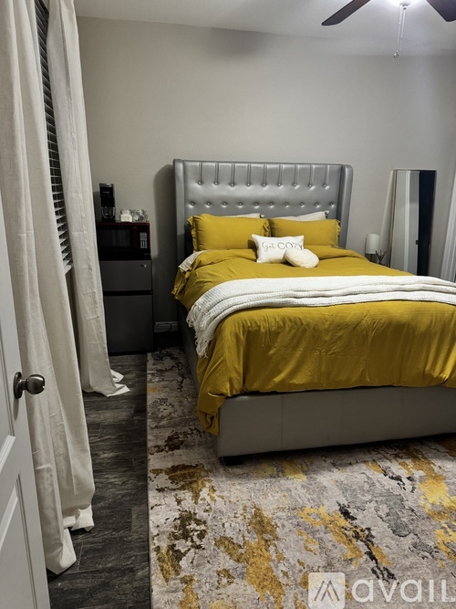 A bedroom with a large bed and a television.