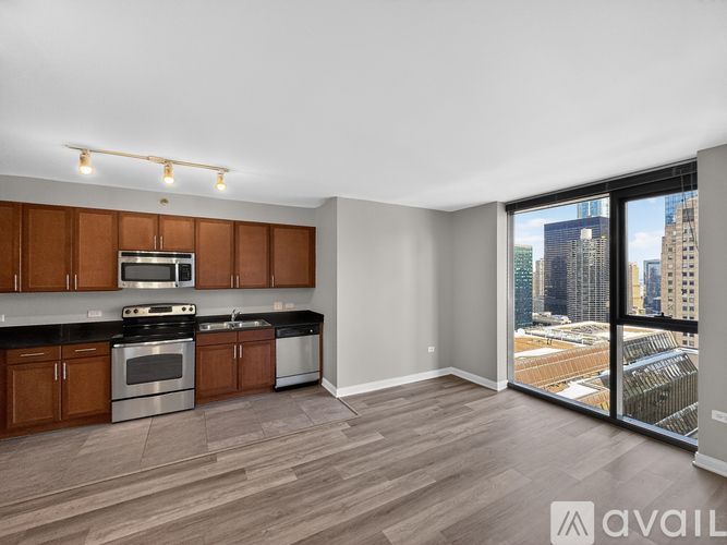 A kitchen with wooden cabinets and a stainless steel stove top oven.