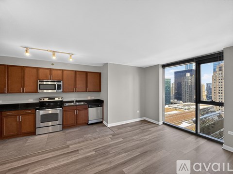 A kitchen with wooden cabinets and a stainless steel stove top oven.