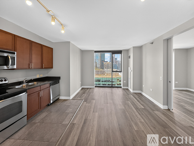 A spacious kitchen with wooden cabinets and a view of the city.
