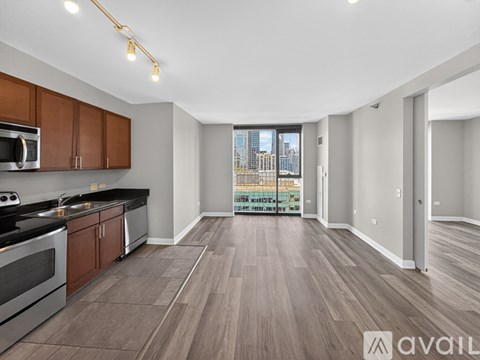 A spacious kitchen with wooden cabinets and a view of the city.