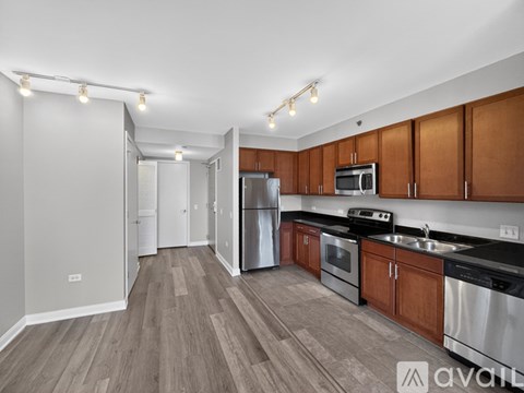 A kitchen with wooden floors and stainless steel appliances.