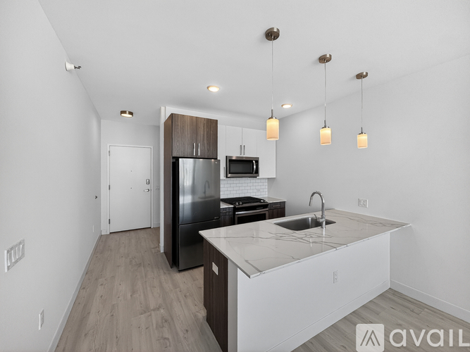 A kitchen with a black fridge and a white counter top.