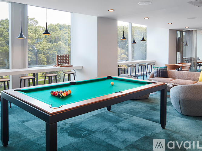A pool table with a green felt cloth and a green pool table ball on it.