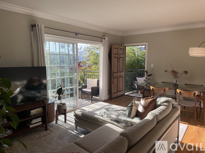A living room with a grey couch and a television.