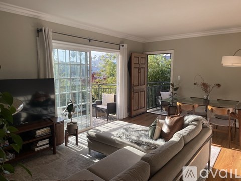 A living room with a grey couch and a television.