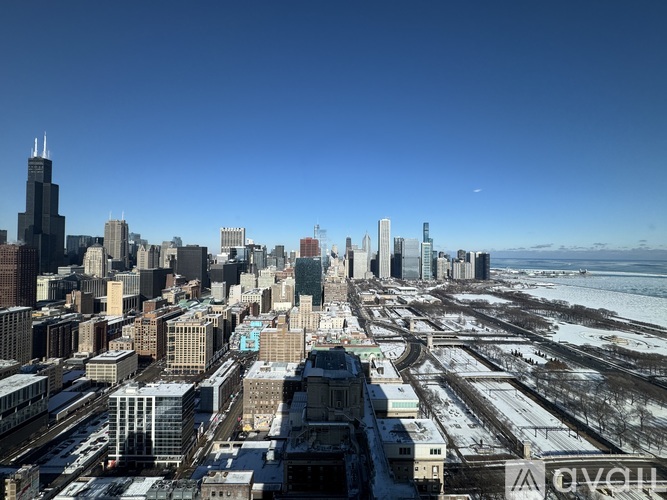 A cityscape with buildings and roads covered in snow.