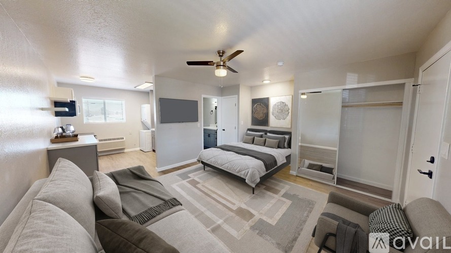 A spacious bedroom with a large bed and a couch.
