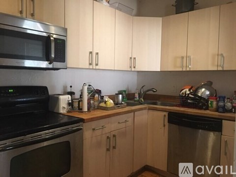 A kitchen with wooden cabinets and a stainless steel oven.