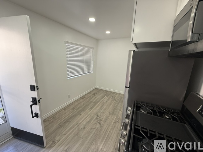 A kitchen area with a stove top oven and a microwave.