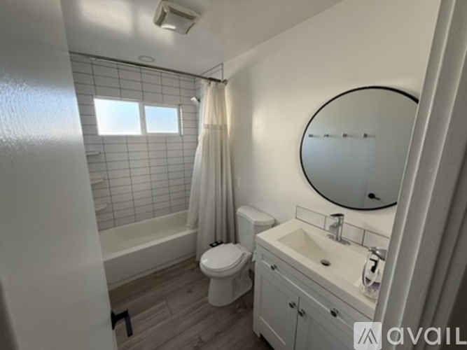 A bathroom with a toilet, sink, and shower.