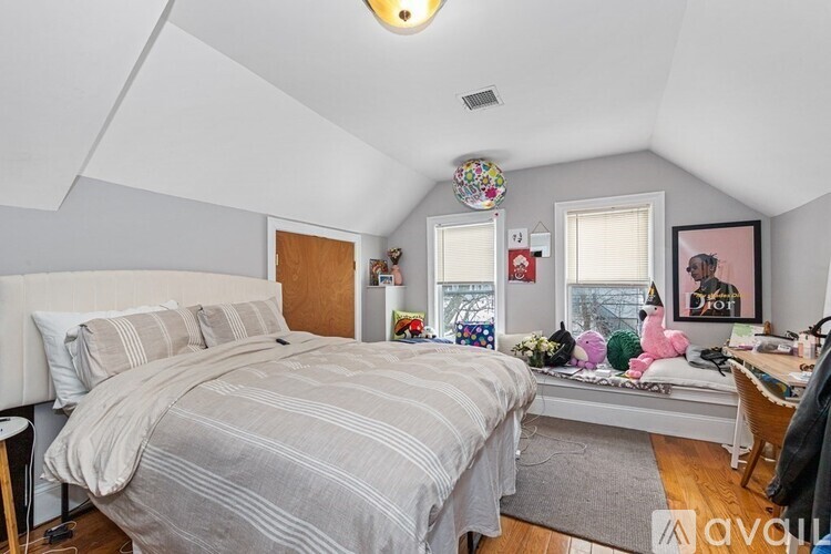 A bedroom with a bed, desk, and chair.