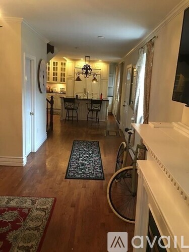 A living room with a fireplace and a bicycle leaning against the wall.