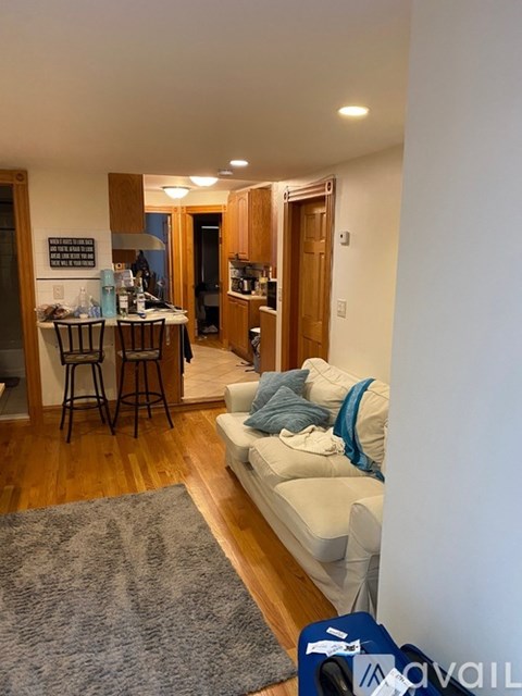 A living room with a couch and a bar area.