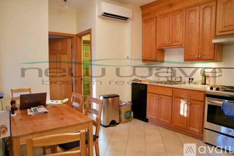 A kitchen with wooden cabinets and a dining table with chairs.
