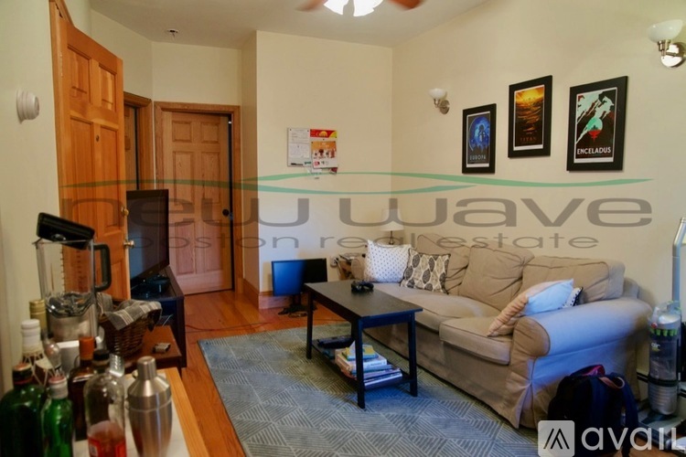 A living room with a couch, a coffee table, and a bar area.