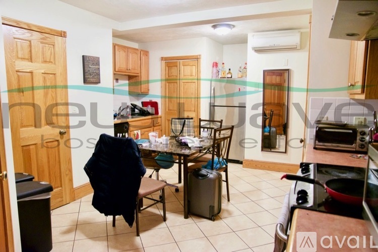 A kitchen with a table and chairs in the middle of the room.