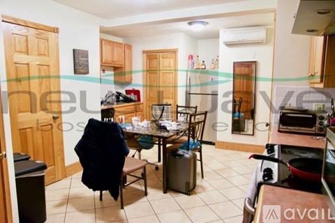 A kitchen with a table and chairs in the middle of the room.