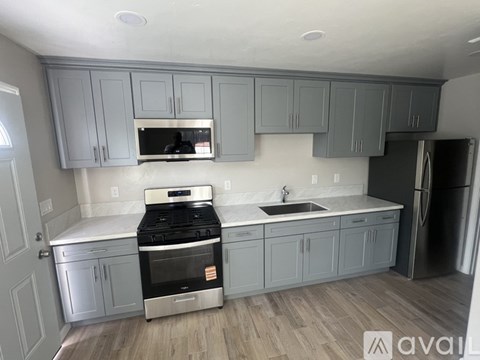 A kitchen with a stove top oven and a refrigerator.