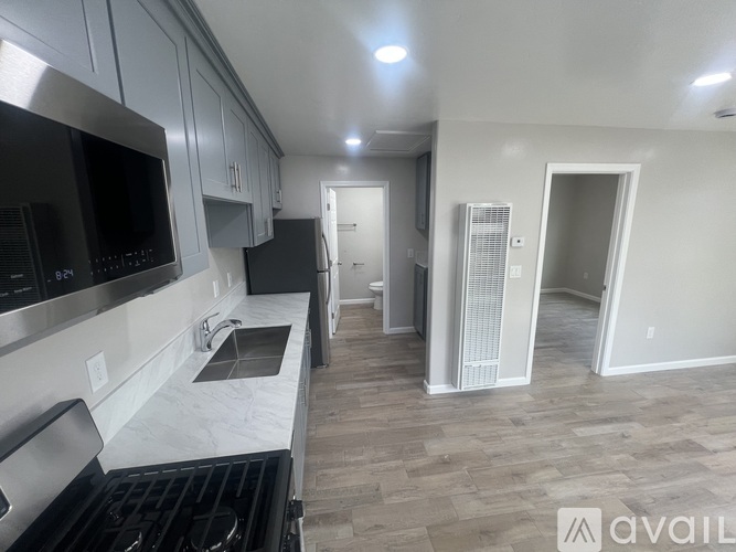 A kitchen with a stove top oven and a microwave.