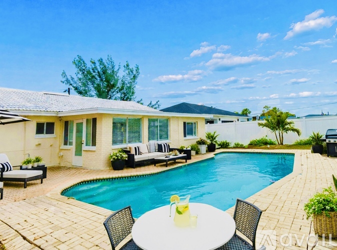 A poolside table with a lemon slice on it.