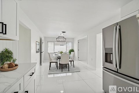 A modern kitchen with a dining table and chairs.