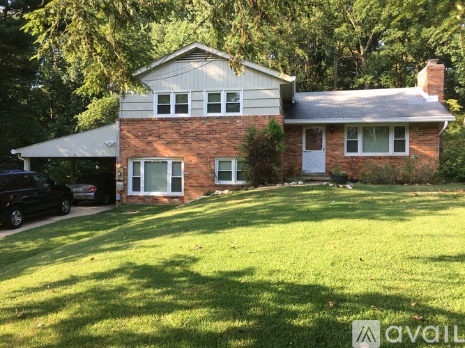A house with a white garage door and a brick chimney.