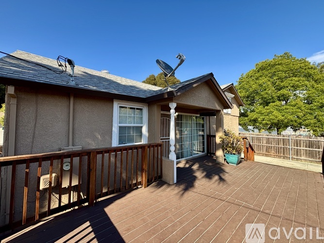 A house with a brown roof and a balcony with a railing.