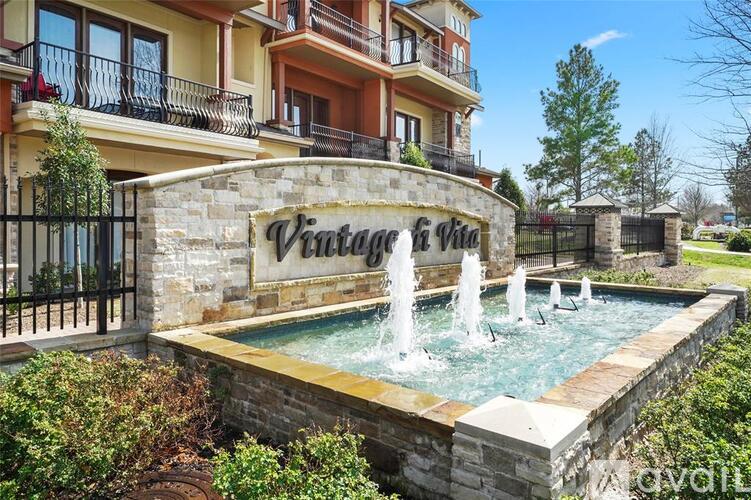 A Vintage at Vista fountain in front of a building.