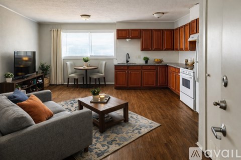 A room with a ceiling fan and wooden flooring.