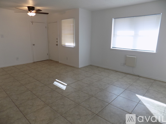 A room with a window and a tiled floor.