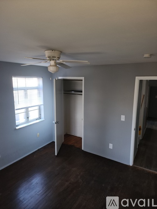 A room with a ceiling fan and a window.