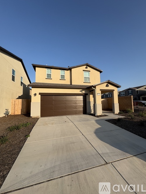 A house with a brown garage door is for sale.