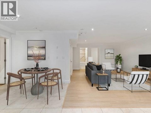 A living room with a dining table and chairs.