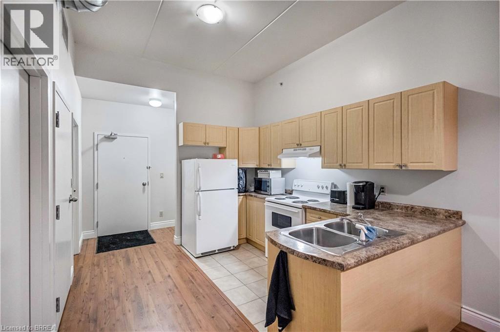 A kitchen with wooden cabinets and a granite countertop.