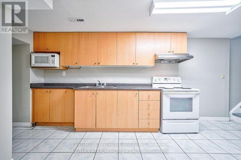 A kitchen with wooden cabinets and a white oven.