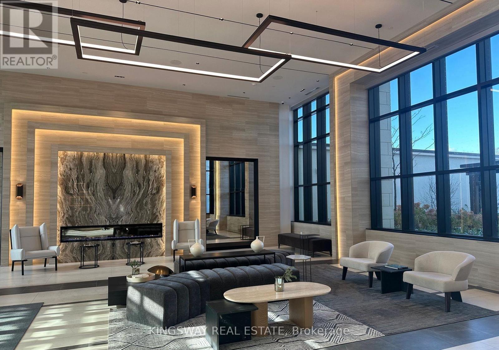 A modern living room with a fireplace and a large window.