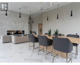 A modern dining room with a marble floor and a large table with chairs.