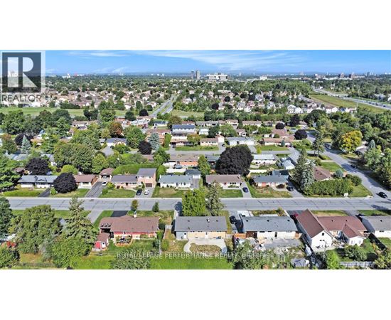 A bird's eye view of a residential area with houses and trees.