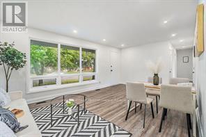 A dining room with a table set for two and a large window.