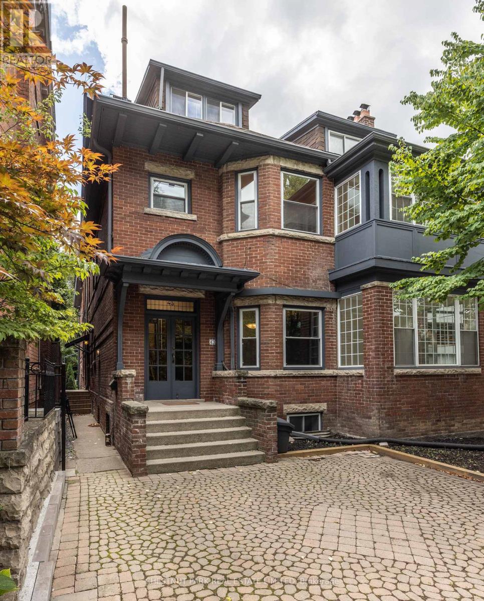 A large house with a black front door and a brick facade.