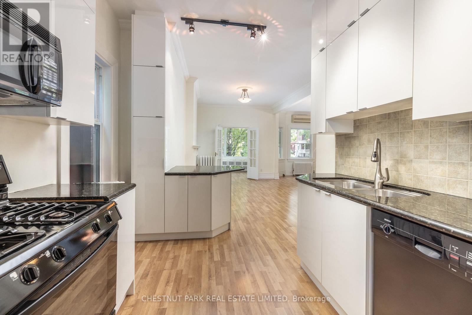 A modern kitchen with a stove top oven and a dishwasher.