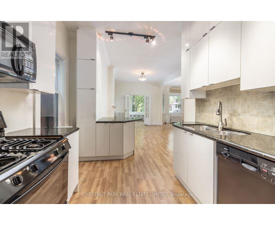 A modern kitchen with a stove top oven and a dishwasher.