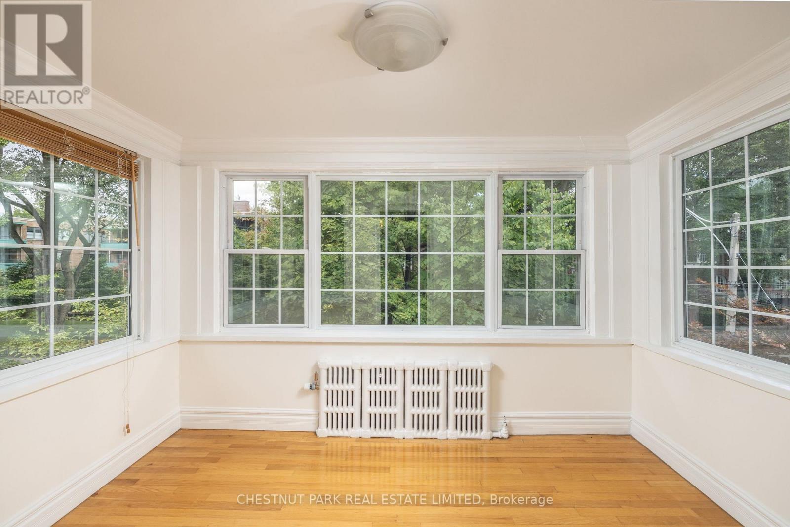 A room with a window and a radiator.