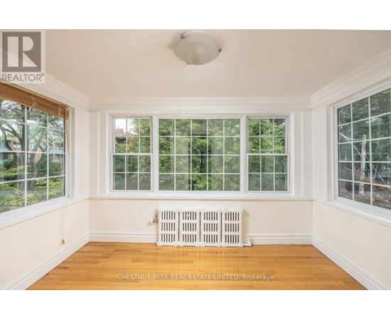 A room with a window and a radiator.