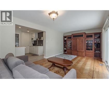 A living room with a grey couch and a wooden coffee table.