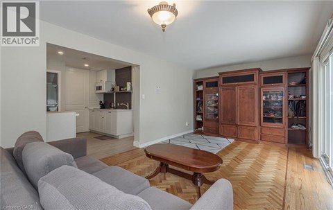 A living room with a grey couch and a wooden coffee table.