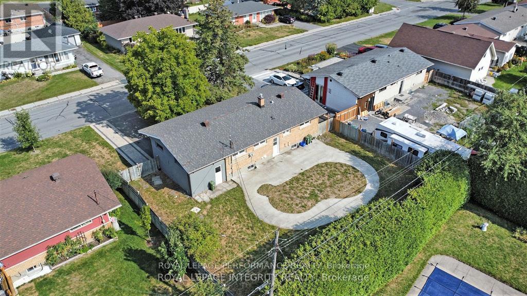 A bird's eye view of a residential area with a swimming pool.