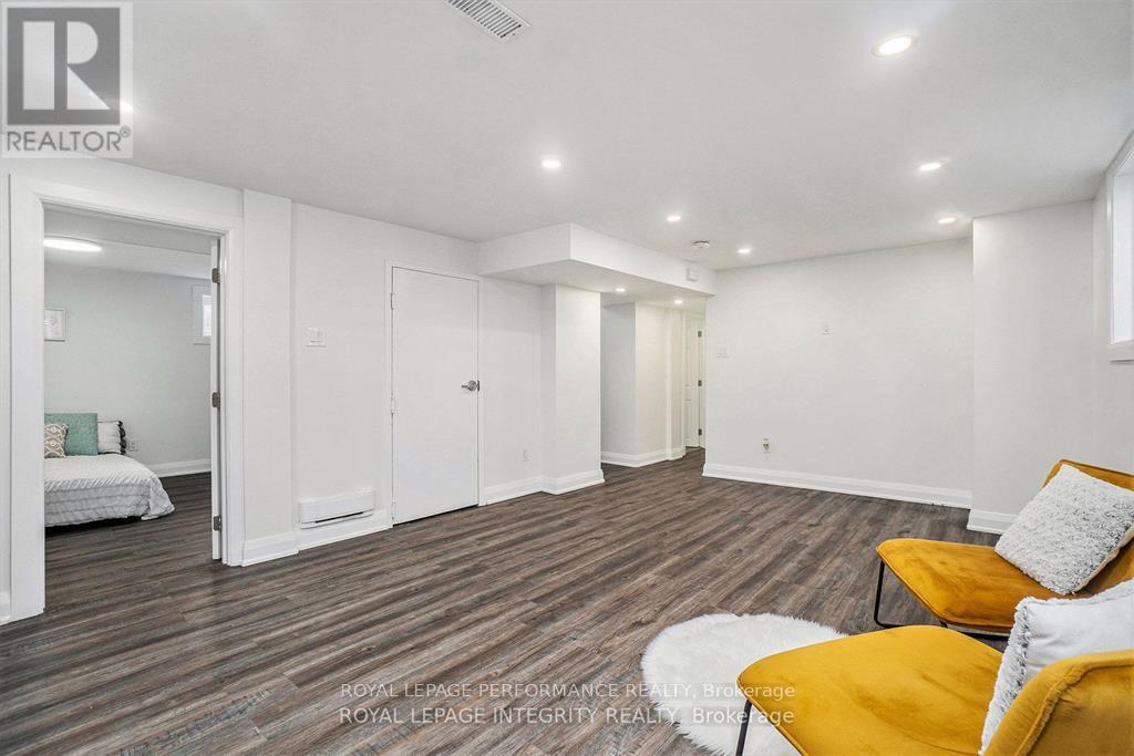 A bedroom with a bed, a chair, and a couch.