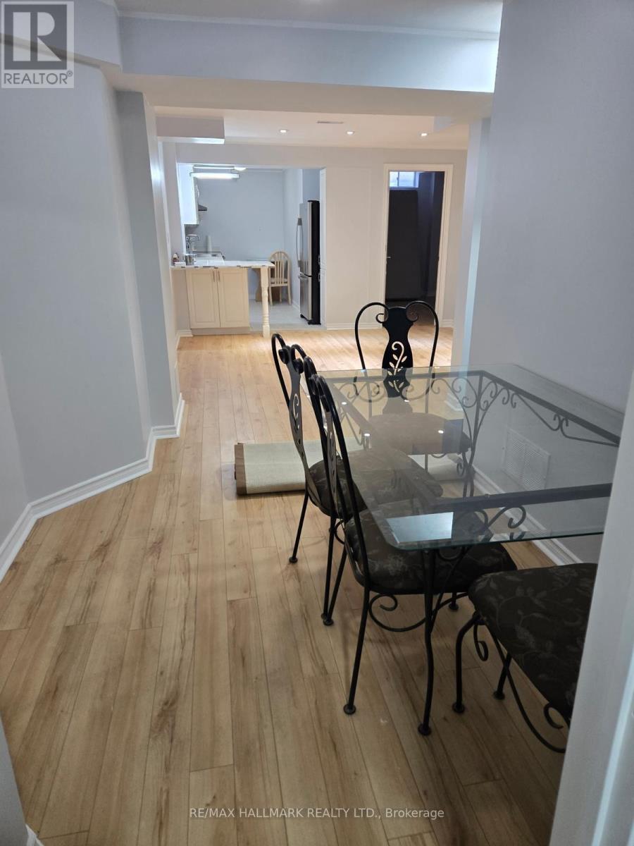 A dining room with a glass table and chairs.